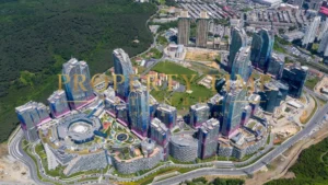 Aerial view of the Maslak 1453 complex at the forest edge: towers, crescent-shaped terraced blocks and mall